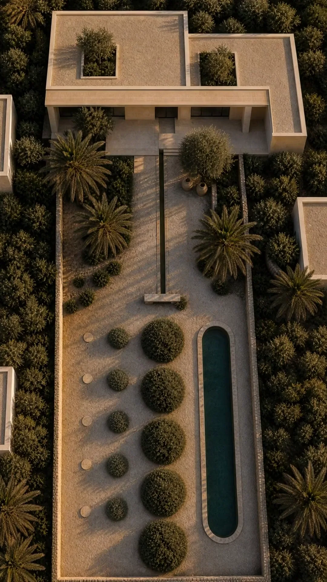 A garden from directly above: a stone villa, a water channel running down to a limestone bench, a row of clipped olive balls beside a long narrow pool, palms all around